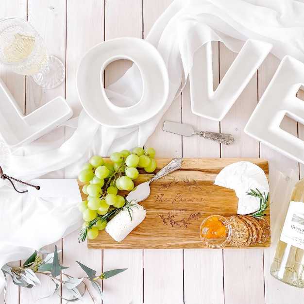 Inspiration - "LOVE" plates set on a tabletop with charcuterie board and wine bottle